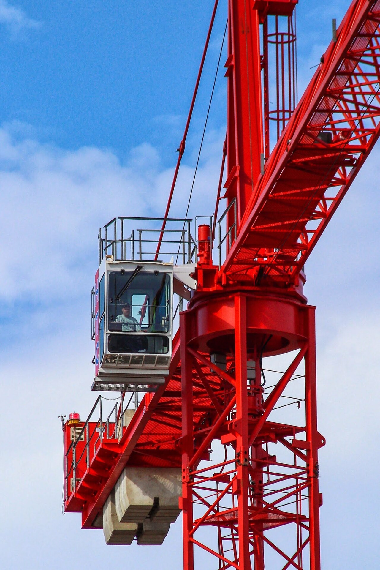 Crane operator working on construction equipment